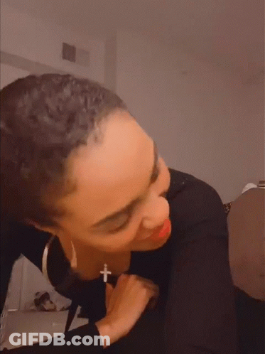 Woman Wearing Black Shirt And Cross Necklace Making Funny Face GIF