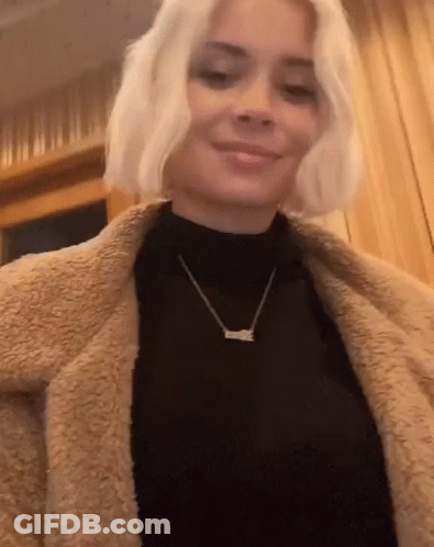 Woman Wearing Black Turtleneck And Love Necklace GIF