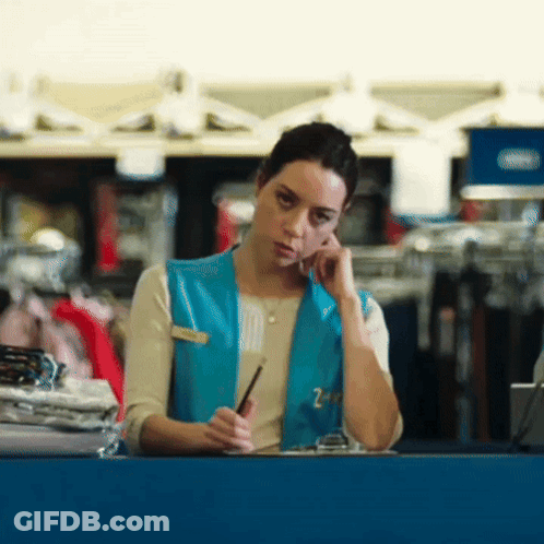 Woman Wearing Blue Vest With Z On Phone GIF