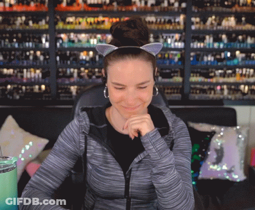 Woman Wearing Cat Ear Headband And Earrings GIF