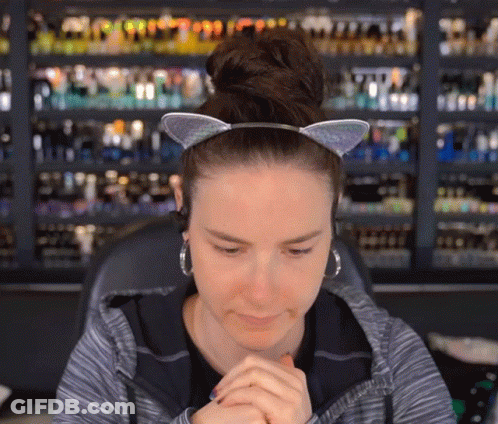 Woman Wearing Cat Ear Headband And Earrings GIF