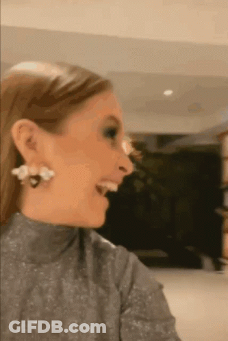 Woman Wearing Earrings And Turtleneck GIF