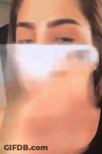 Woman Wearing Face Mask Holding Cell Phone GIF