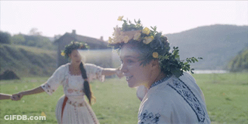 Woman Wearing Flower Wreath Holding Nose GIF