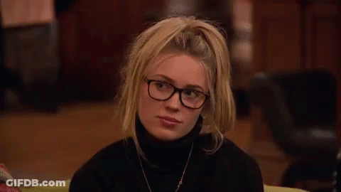 Woman Wearing Glasses And Black Turtleneck Smiling GIF