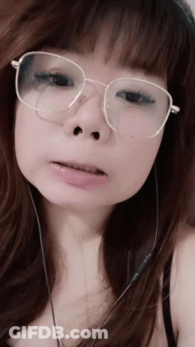 Woman Wearing Glasses And Earbuds GIF