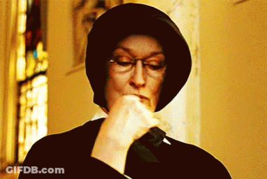Woman Wearing Glasses And Hat Holding Knife In Mouth GIF