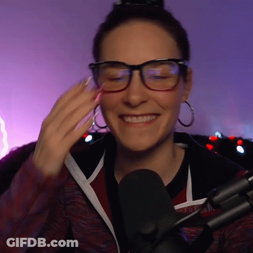 Woman Wearing Glasses And Hoop Earrings Smiling GIF