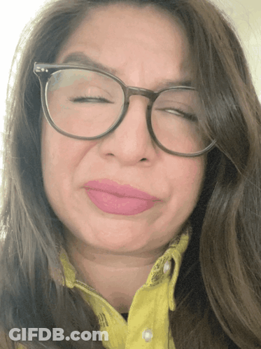 Woman Wearing Glasses And Yellow Shirt Making Funny Face GIF