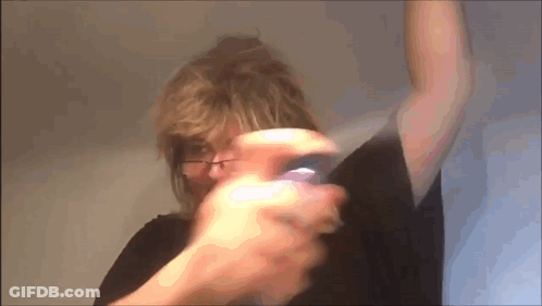 Woman Wearing Glasses Holding Purple Object GIF