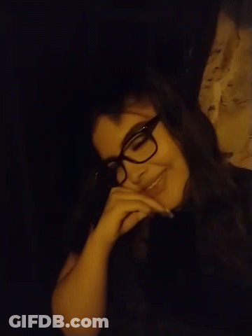 Woman Wearing Glasses Lying Down Smiling GIF