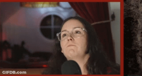Woman Wearing Glasses Talking Into Microphone GIF