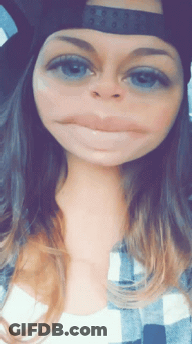 Woman Wearing Hat And Plaid Shirt Making Face GIF