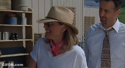 Woman Wearing Hat Next To Man GIF