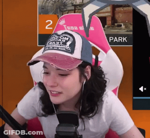 Woman Wearing Hat That Says No Om Misar Sits In Chair GIF