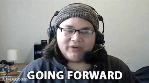 Woman Wearing Headphones And Beanie Says Going Forward GIF