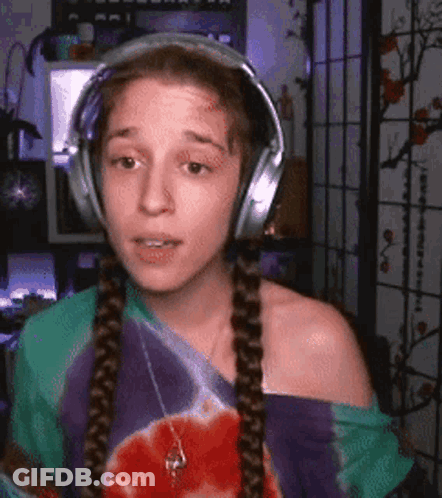 Woman Wearing Headphones And Tie Dye Shirt GIF