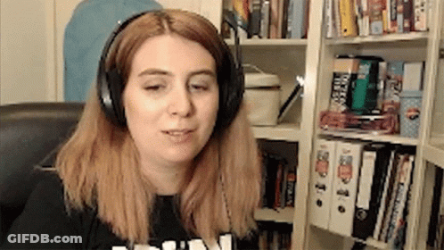Woman Wearing Headphones In Front Of Bookshelf GIF