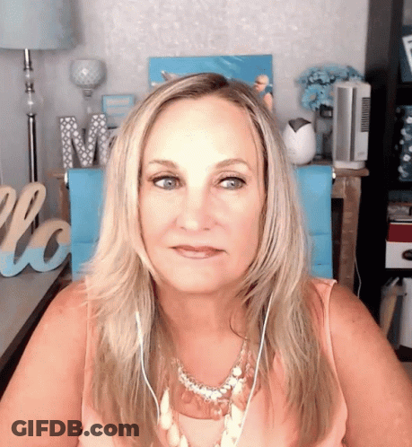Woman Wearing Headphones In Front Of Love Sign GIF
