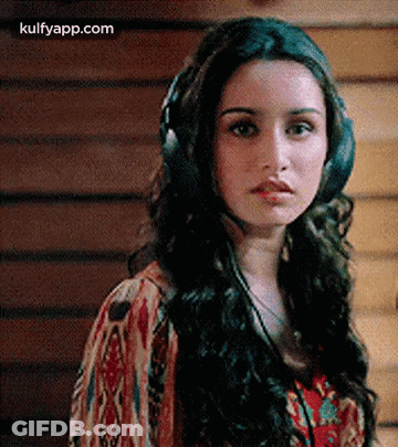 Woman Wearing Headphones Looking At Camera GIF