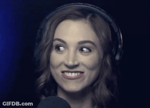 Woman Wearing Headphones Looks At Camera GIF