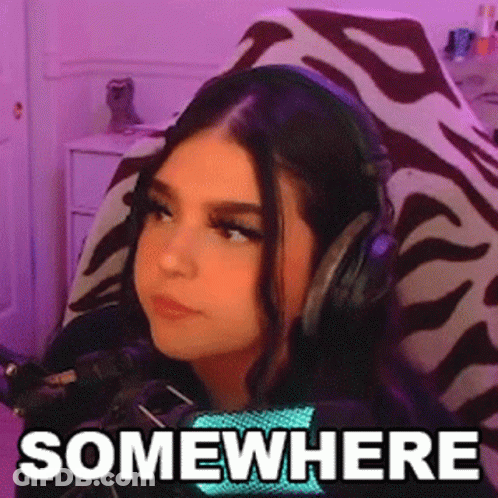 Woman Wearing Headphones Sitting In Chair Saying Somewhere GIF