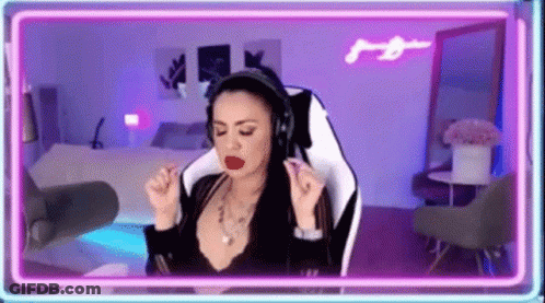 Woman Wearing Headphones Sitting In Front Of Neon Light GIF