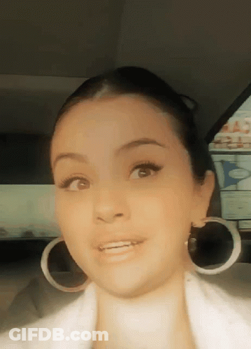 Woman Wearing Hoop Earrings And White Jacket GIF