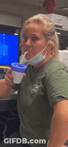 Woman Wearing Mask Holding Cup GIF
