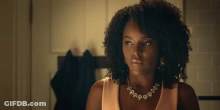 Woman Wearing Necklace And Earrings Looking At Camera GIF