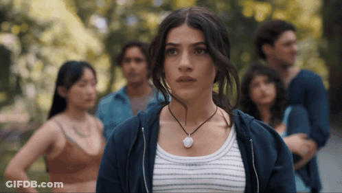 Woman Wearing Necklace In Front Of Crowd GIF