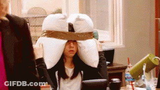Woman Wearing Pillow On Head At Desk GIF