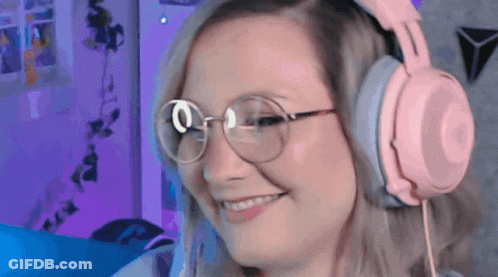 Woman Wearing Pink Headphones And Glasses Smiling GIF