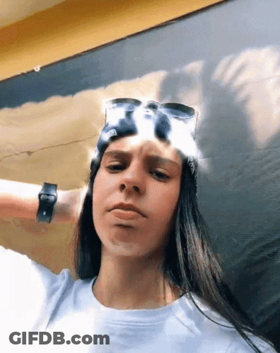 Woman Wearing Sunglasses And Bandana Making Face GIF