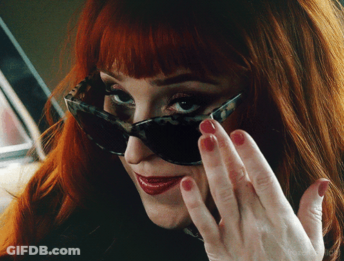 Woman Wearing Sunglasses And Red Nail Polish GIF