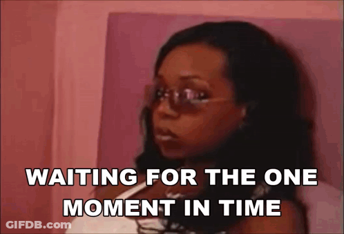 Woman Wearing Sunglasses Sitting On Bed GIF
