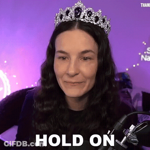 Woman Wearing Tiara Saying Hold On At Microphone GIF