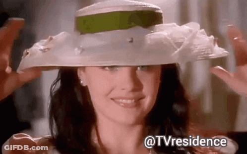 Woman Wearing White Hat With Green Ribbon Smiling GIF