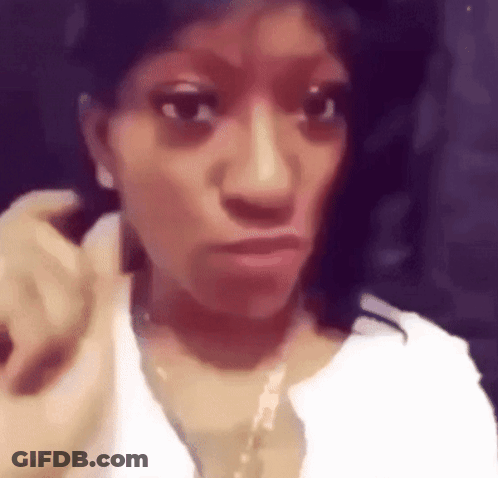 Woman Wearing White Shirt And Gold Necklace Making Face GIF