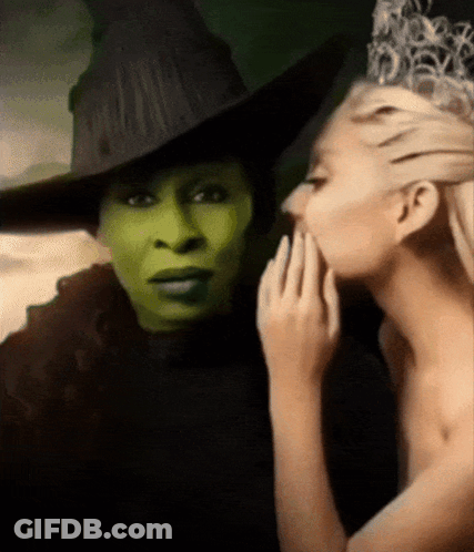 Woman Whispering Into Witch's Ear GIF