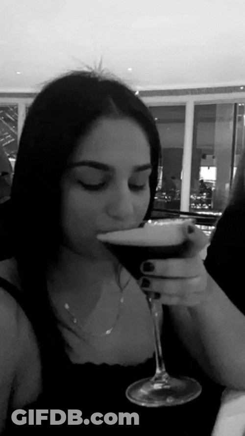 Woman Winks And Drink Espresso Cocktail GIF