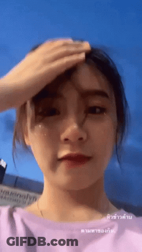 Woman Wiping Forehead In Pink Top GIF