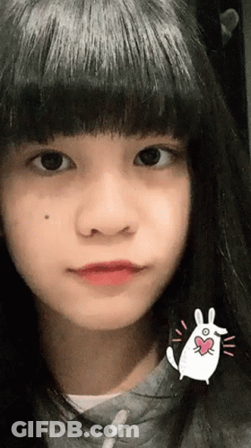 Woman Wiping Forehead In Pink Top GIF