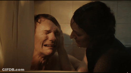 Woman Wiping Man's Face In Bathroom GIF