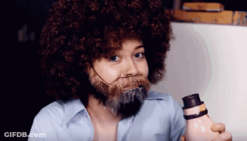 Woman With Afro And Beard Holding Bottle GIF