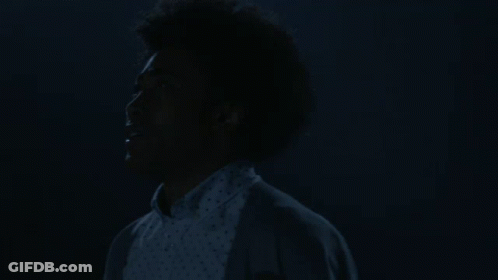 Woman With Afro Eyes Closed In Dark GIF