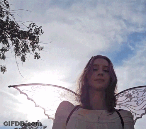 Woman With Angel Wings By Tree GIF