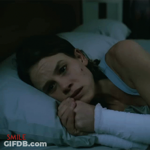 Woman With Arm Bandage Lying On Bed Smile GIF