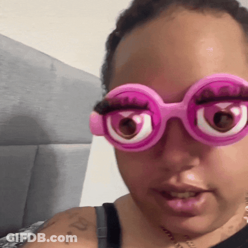 Woman With Arm Tattoo And Pink Glasses GIF