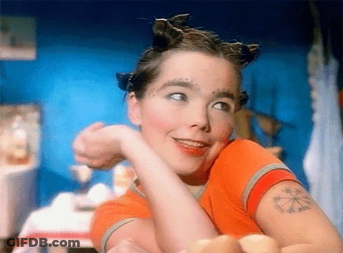 Woman With Arm Tattoo Smiling At Camera GIF